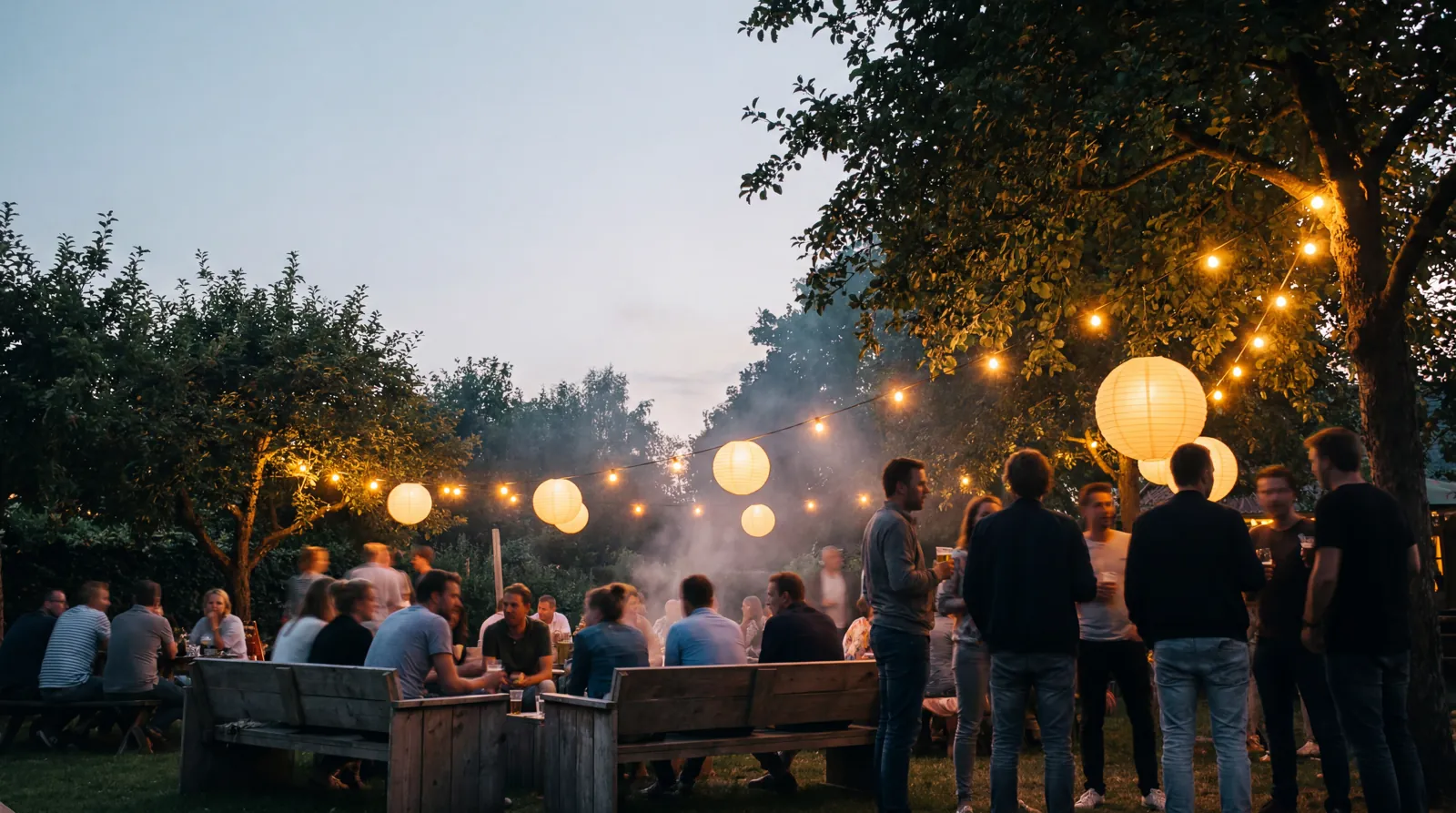 Tuinfeest in de avond met bollampen en lichtsnoeren
